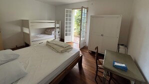 A bedroom with a bunk bed, a single bed, a desk with a chair, and a wardrobe. - Family house with sea view / Beach 10min walk (Ploubazlanec)