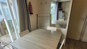 A modern kitchen with a dining area.
