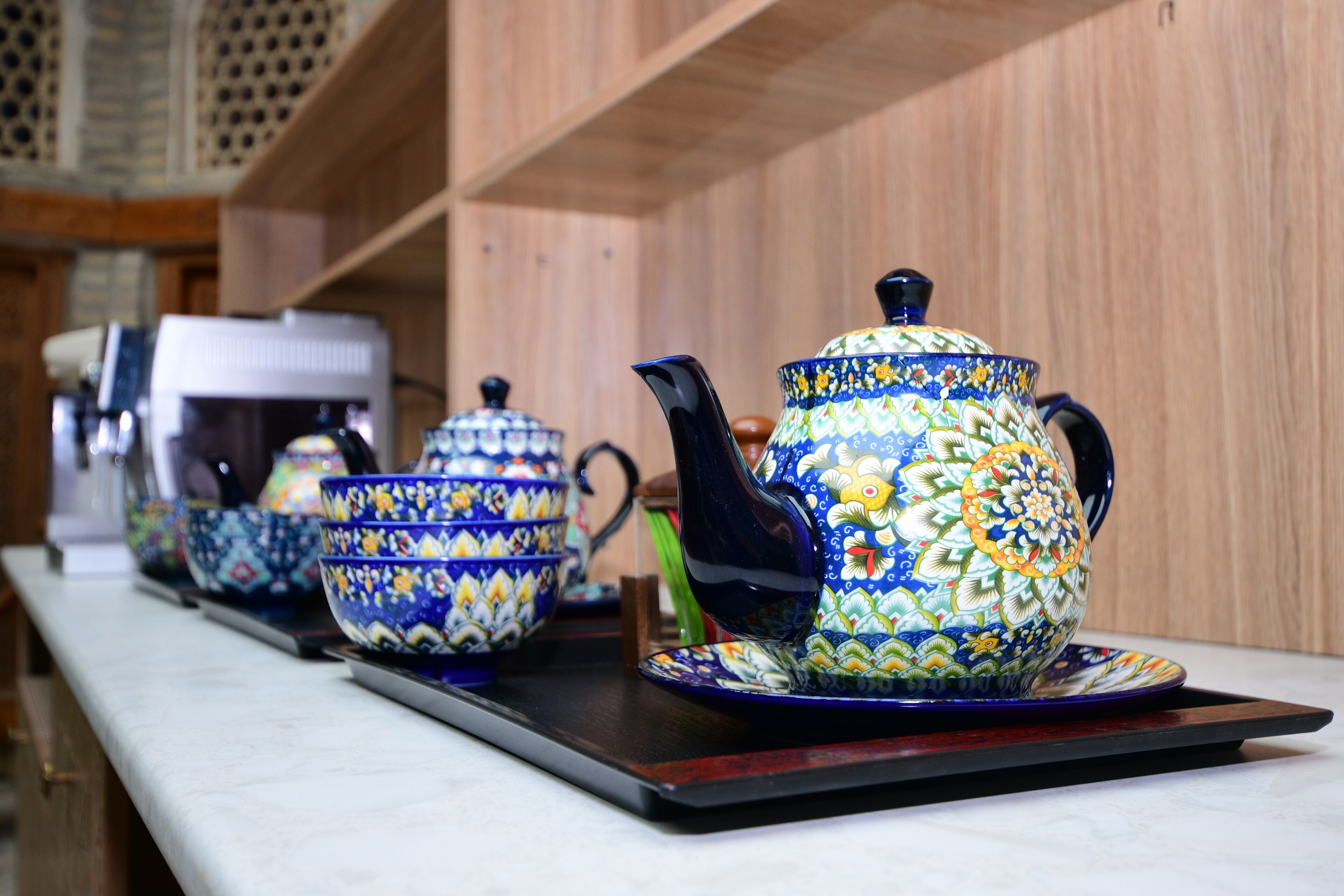 A row of traditional tea sets on a tray.