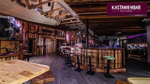 A rustic bar with wooden walls and a central bar area. - Apartment in St. Georgen Near Kreischbergbahn (Sankt Georgen am Kreischberg)