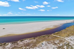 A beach with a clear sky and calm sea.