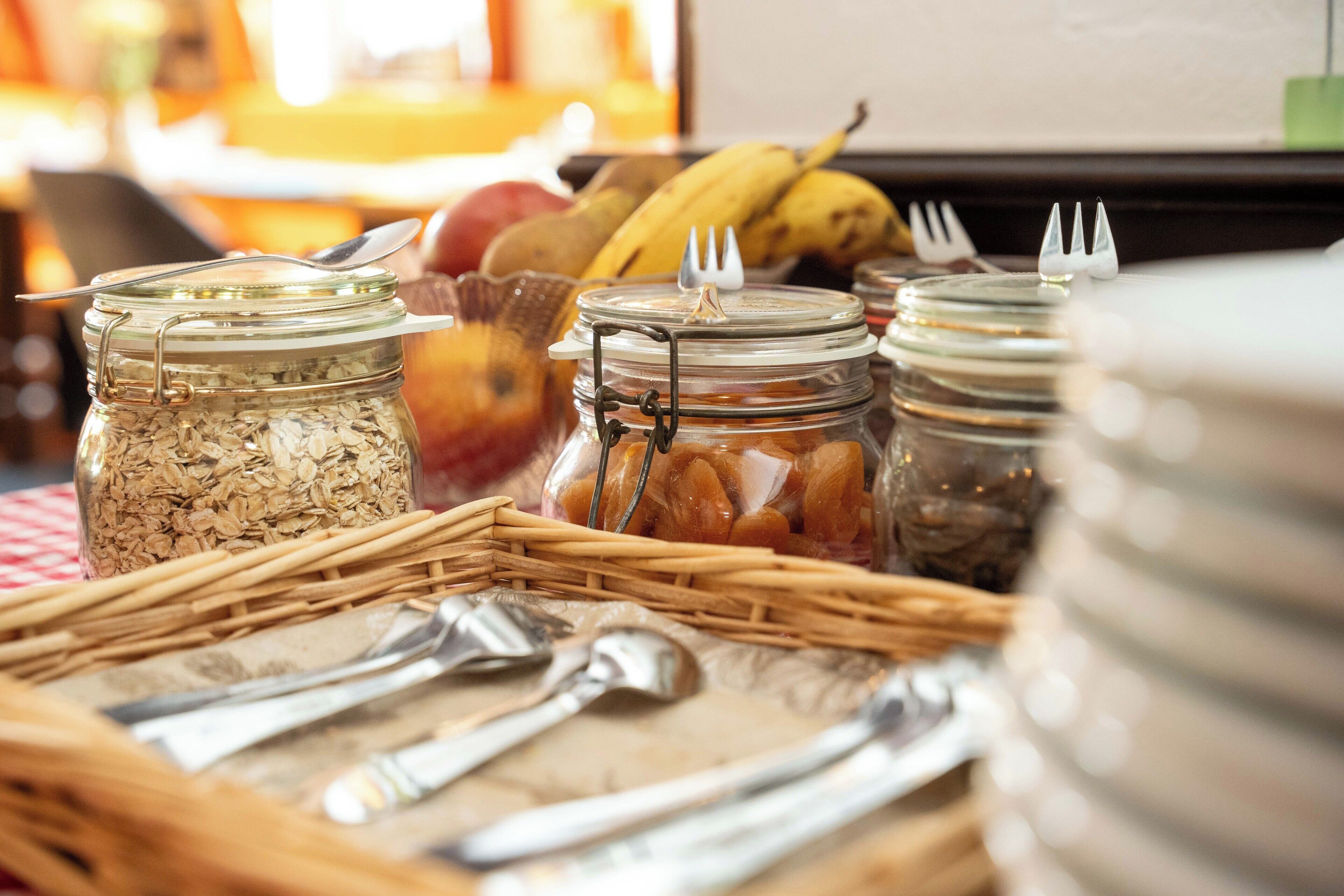 A breakfast buffet with various food items and utensils.