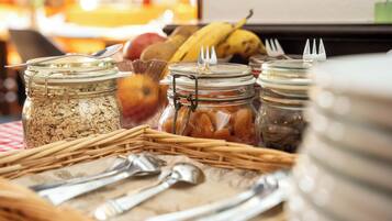 A breakfast buffet with various food items and utensils.
