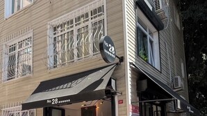 A building with a black awning displaying the number 28. - Bosphorus View Duplex in Central Istanbul  2BR  Sleeps 6 (Istanbul)