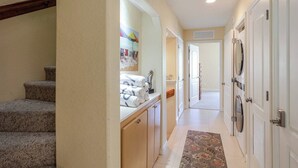 A hallway with carpeted stairs, a bathroom with a shower, and a door with a mirror. - Relaxing 3 Bdr Keys Retreat - Hate to leave it (Marathon)