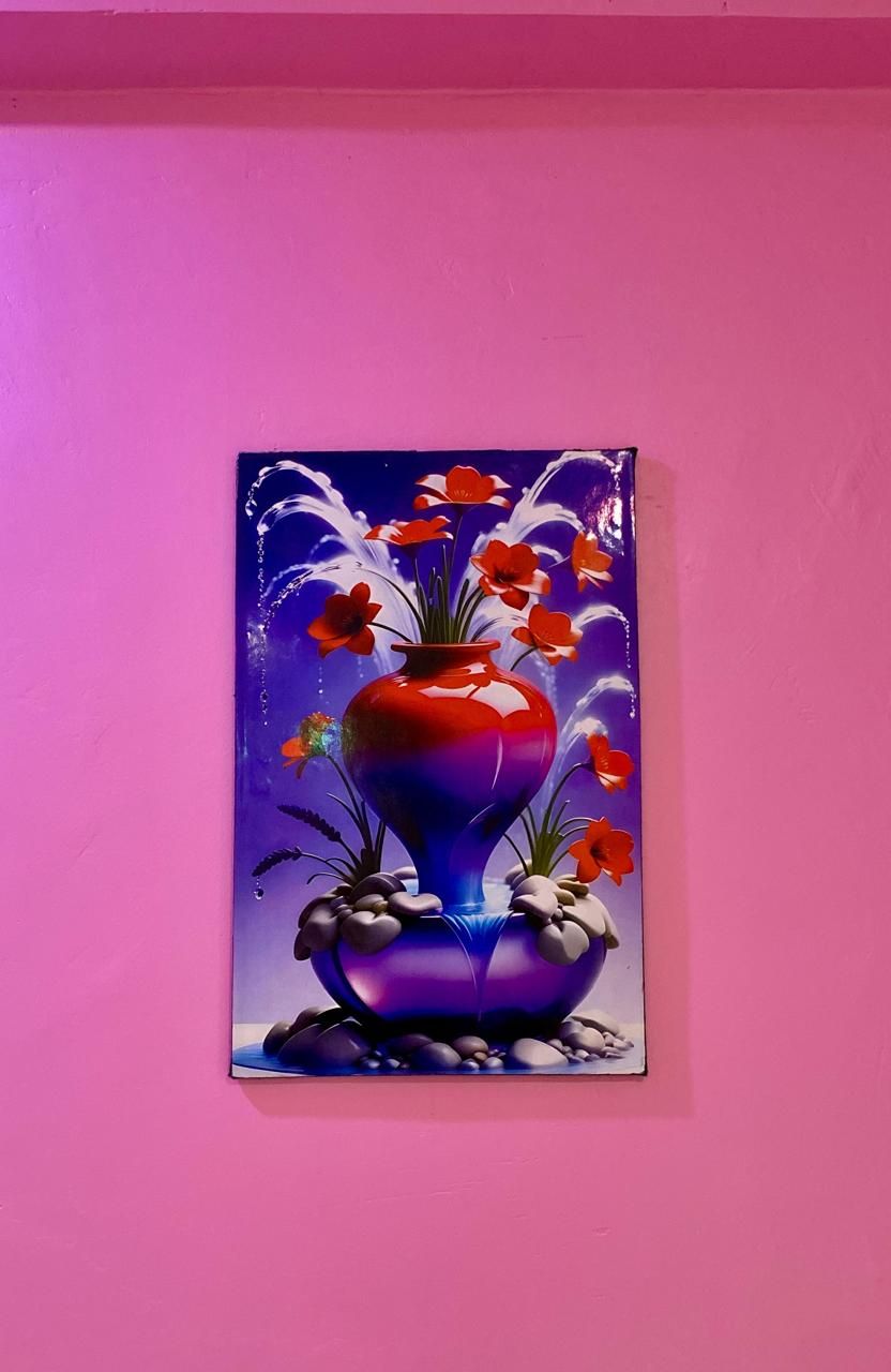A painting of a vase with flowers on a wall.
