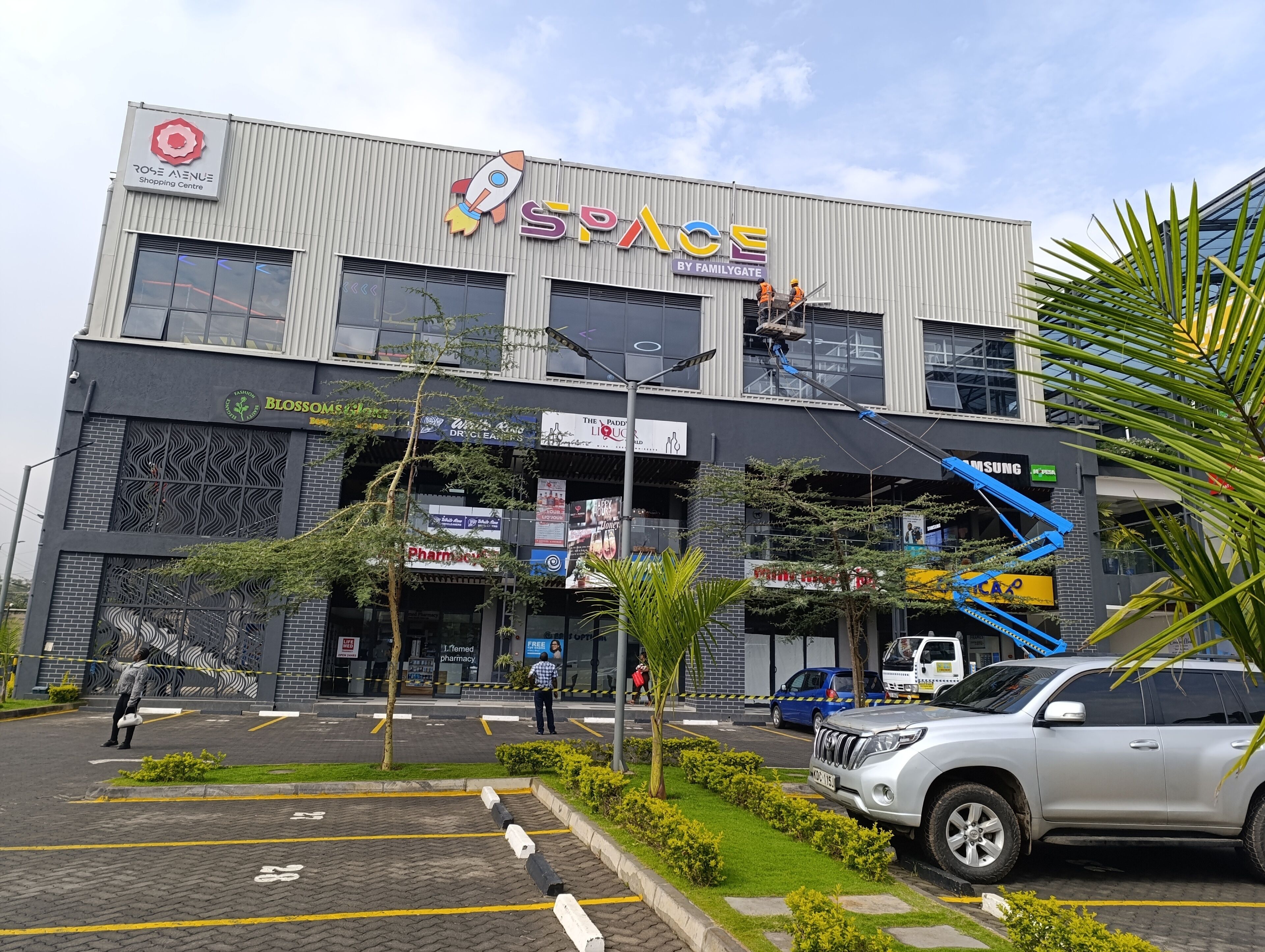 A multi-story building with a prominent 'SPACE' sign, featuring a rocket and the 'BY FAMILYGATE' logo.