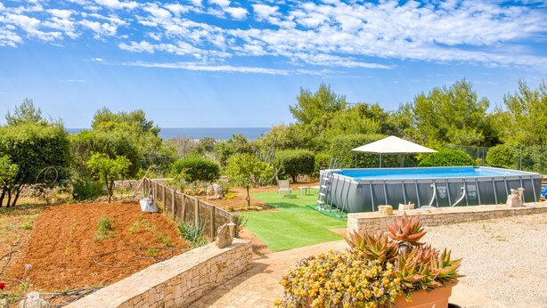 A pool, a patio area, and a view of the sea. - Villa 'Marilor' with Sea View, Wi-Fi, and Air Conditioning (Salve)