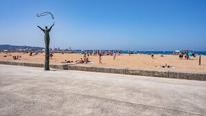 A beach with a statue, sandy beach, and a clear sky. - Holiday Home 'Little Yellow House' with Private Terrace (Gijón)