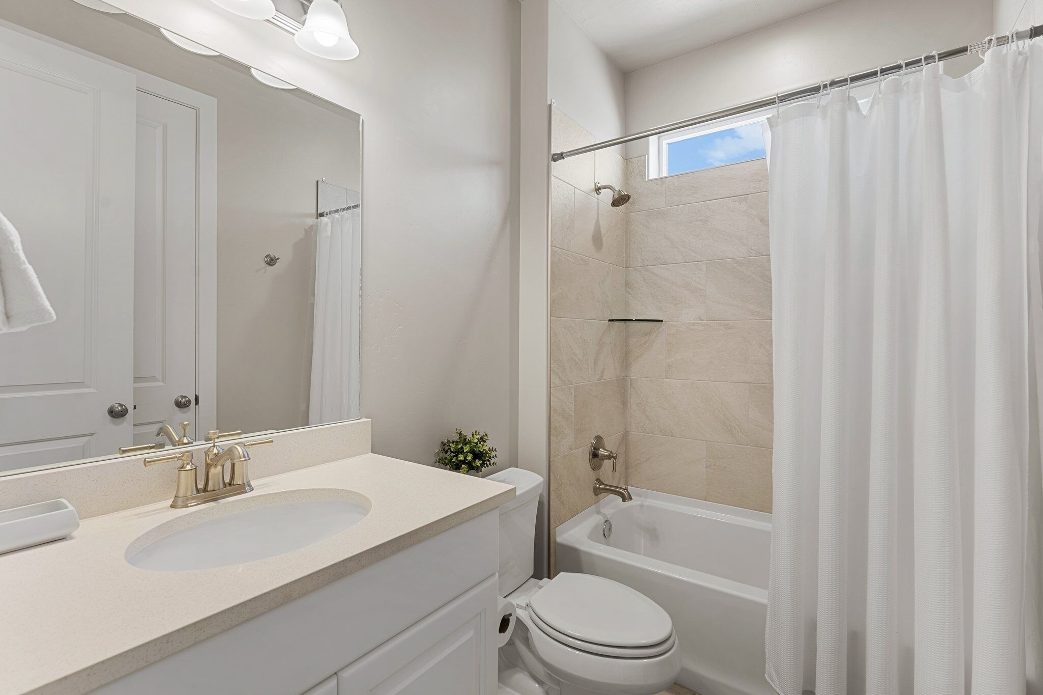 A bathroom with a sink, toilet, and bathtub.