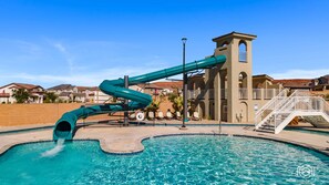 A swimming pool with a water slide, a lifebuoy, and a white staircase leading to a tower-like structure. - Forever Summer 5 Bedroom Townhouse (Washington)