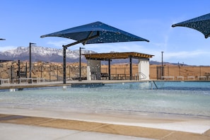 A swimming pool with a mountain backdrop, a covered seating area, and a fenced poolside. - Long Valley Leisure 4 Bedroom Townhouse (Washington)