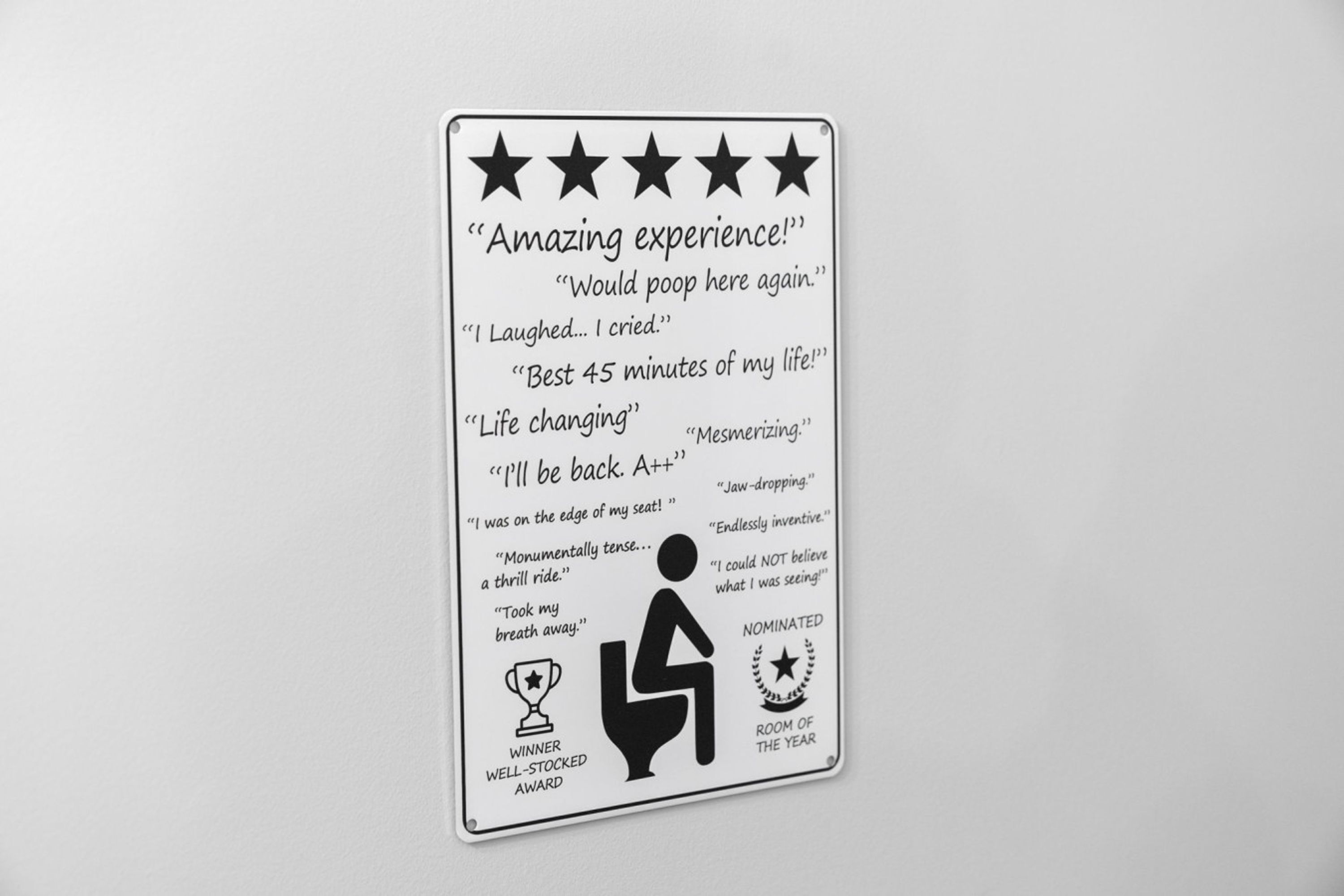 A sign with various customer reviews and awards, including a "Room of the Year" nomination.