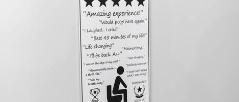 A sign with various customer reviews and awards, including a "Room of the Year" nomination.
