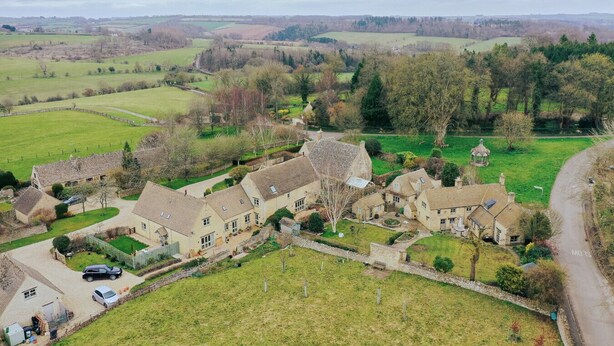 A rural village with traditional stone houses, a central courtyard, and surrounding fields. - Country Cottage in the Heart of the Cotswolds (Cheltenham)