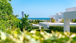 A modern building with white walls and a view of the sea. - Villa 'Dominica' with Sea View, Wi-Fi and Air Conditioning (Estepona)