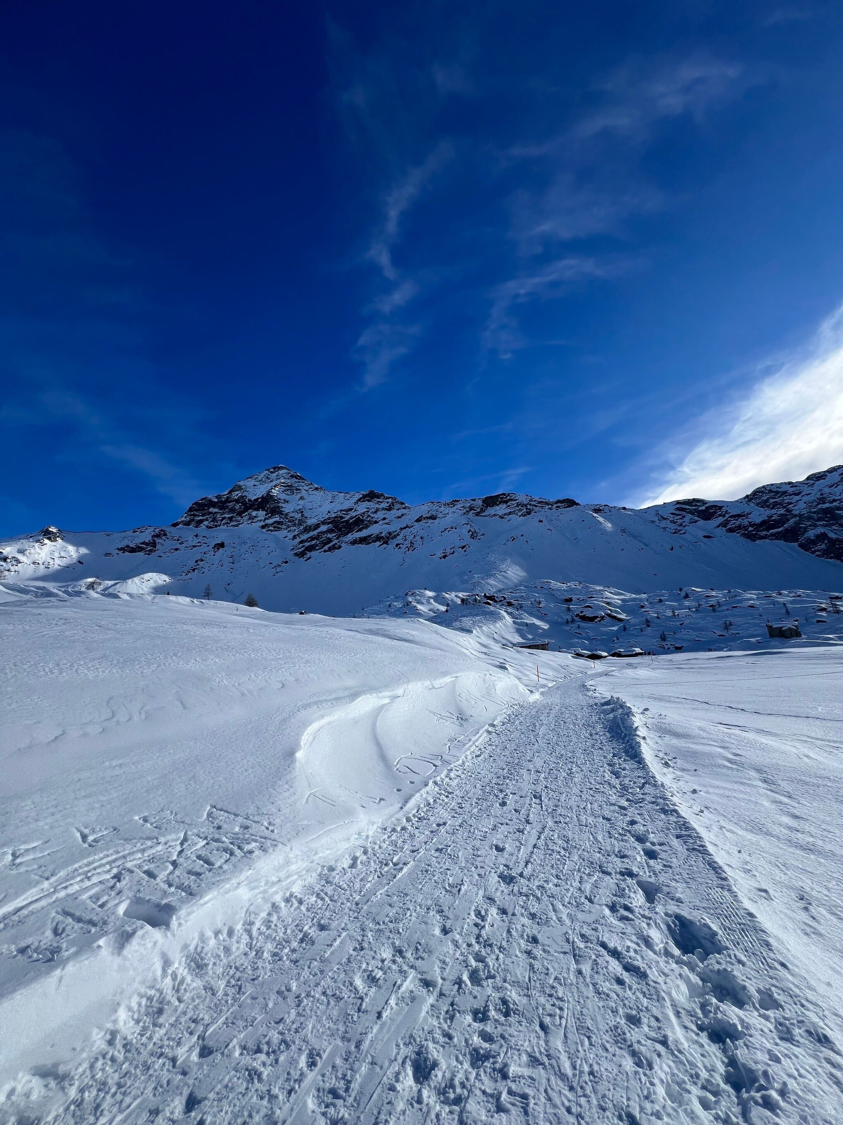 A snow-covered mountain landscape with a clear sky.