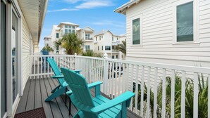 A balcony with teal Adirondack chairs and a white railing. - Inlet Beach + Gulf View, Pet Friendly & Bikes (Inlet Beach)