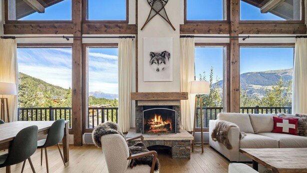 A cozy living room with a fireplace, wooden beams, and a scenic mountain view. - 200m ski slopes-Chalet Manora -Courchevel La Tania (Courchevel)