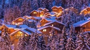 A cluster of log cabins with snow-covered roofs, surrounded by dense forest. - 200m ski slopes-Chalet Manora -Courchevel La Tania (Courchevel)