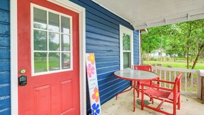 A porch with a red door, a small table, and red chairs. - 1 Mi to Ocala Dtwn Square: Home w/ Yard! (Ocala)