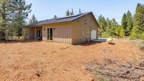 A single-story building with a sloped roof, a front door, and a small porch area. - 2 Mi to Lake Almanor: Home w/ Golf Course Views! (Westwood)
