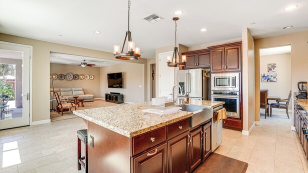 A spacious kitchen with granite countertops, stainless steel appliances, and wooden cabinets. - Family Home w/ Patio & Fenced Yard in Brentwood (Brentwood)