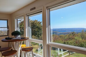 A room with large windows, a small table, and two chairs. - Fall Foliage Mountainside Views, Minutes To Jim Thorpe, Hot Tub & Game Room (Jim Thorpe)