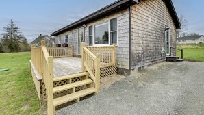 A wooden cabin with a deck, a front door, and a window. - Day Trip to Acadia: Quiet Coastal Maine Escape (Harrington)