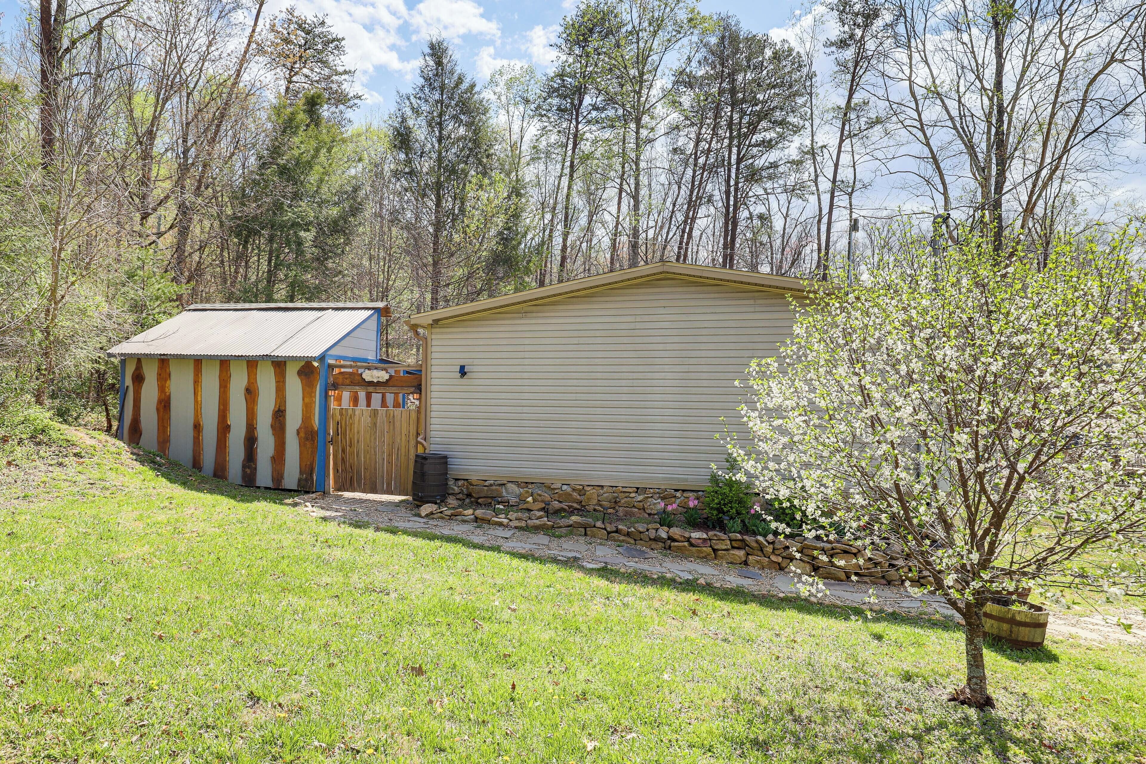 A single-story building with a gabled roof, a small porch, and a stone foundation.