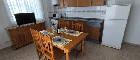 Fridge, microwave, coffee/tea maker, cookware/dishes/utensils