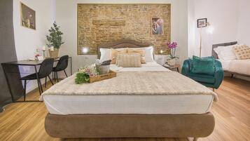 Relax in a spacious room with a large bed, desk, and comfortable seating area.