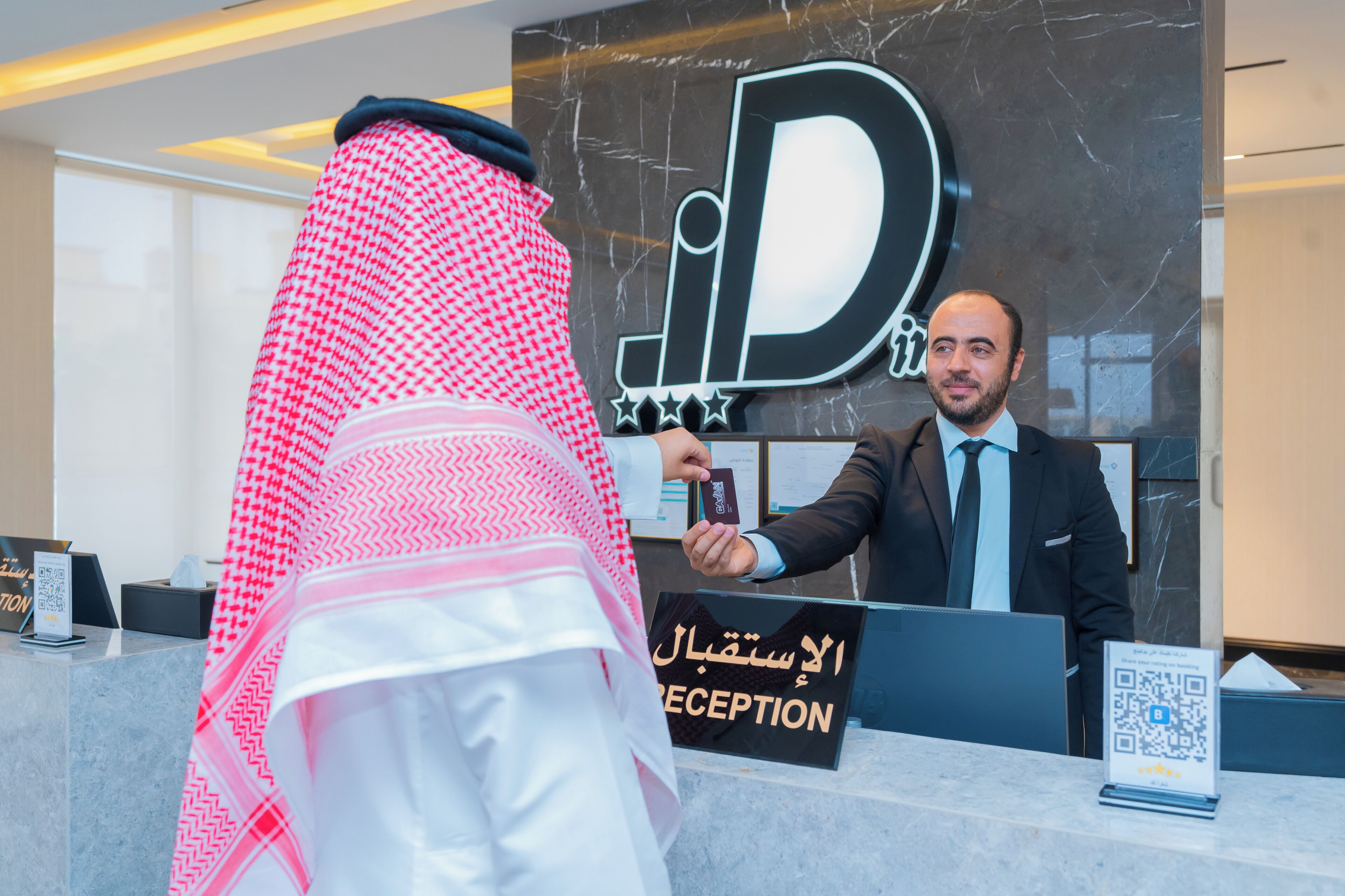 A reception desk with a sign that reads "RECEPTION" and a QR code.