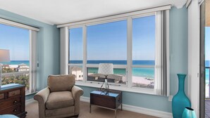 A room with a large window offering a view of the beach and ocean. - Great Beach Views from 6th Floor at Hidden Dunes! (Miramar Beach)