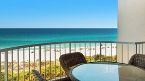 A balcony with wicker furniture overlooking a beach and ocean. - Great Beach Views from 6th Floor at Hidden Dunes! (Miramar Beach)