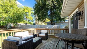 A wooden deck with wicker furniture, including sofas and a table. - 4.2 mi - TBK Sports Complex, 8.6 mi - Airport (Bettendorf)