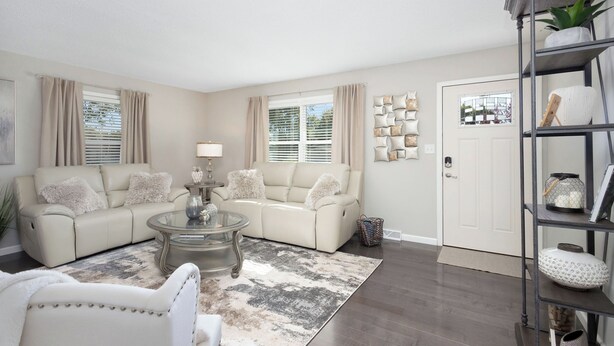 A living room with a beige sofa, a glass coffee table, and a patterned rug. - 4.2 mi - TBK Sports Complex, 8.6 mi - Airport (Bettendorf)