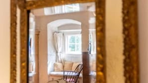 A room with a window, a chair, and a mirror. - Spedlins Castle – A Magical Escape in the Scottish Countryside (Templand)