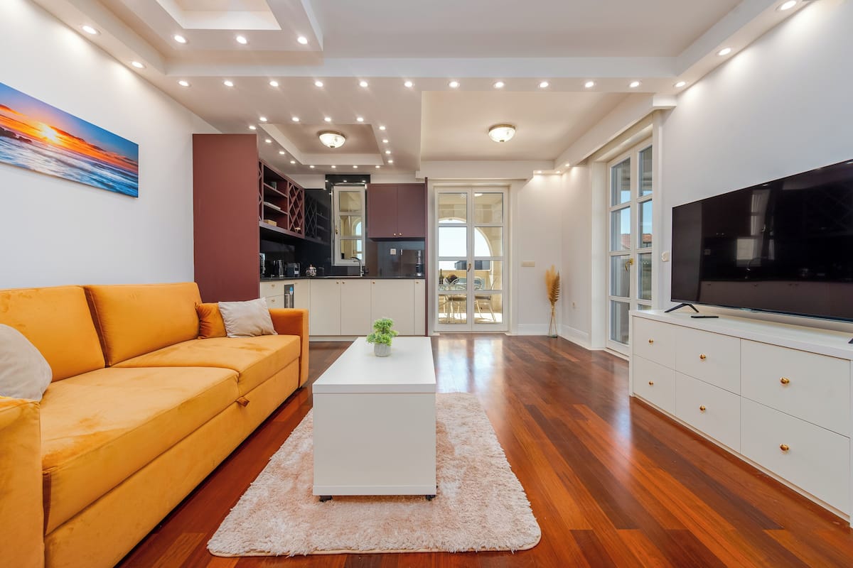 Deluxe Apartment, Partial Sea View | Living area | TV