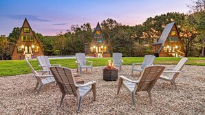 A triangular lodge with a fire pit and outdoor seating. - Luxury Adults-Only A-Frames |Table Rock (Omaha)