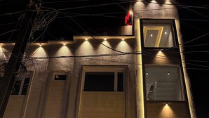 A hotel named "Hotel Akaaay" with a modern facade, multiple windows, and a sign indicating the presence of a bank nearby. - Hotel Akaay (Ujjain)