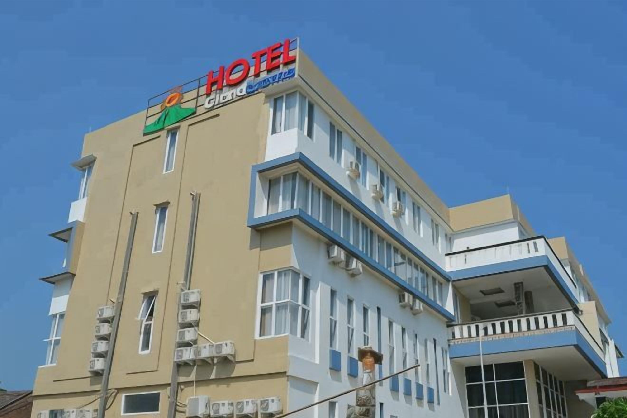 A hotel building with a prominent 'HOTEL' sign, multiple floors, and balconies.