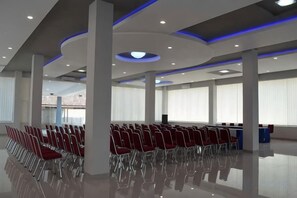 A spacious hall with rows of chairs, large windows, and a modern ceiling design. - Hotel Grand Bromo Pacitan (Pacitan)