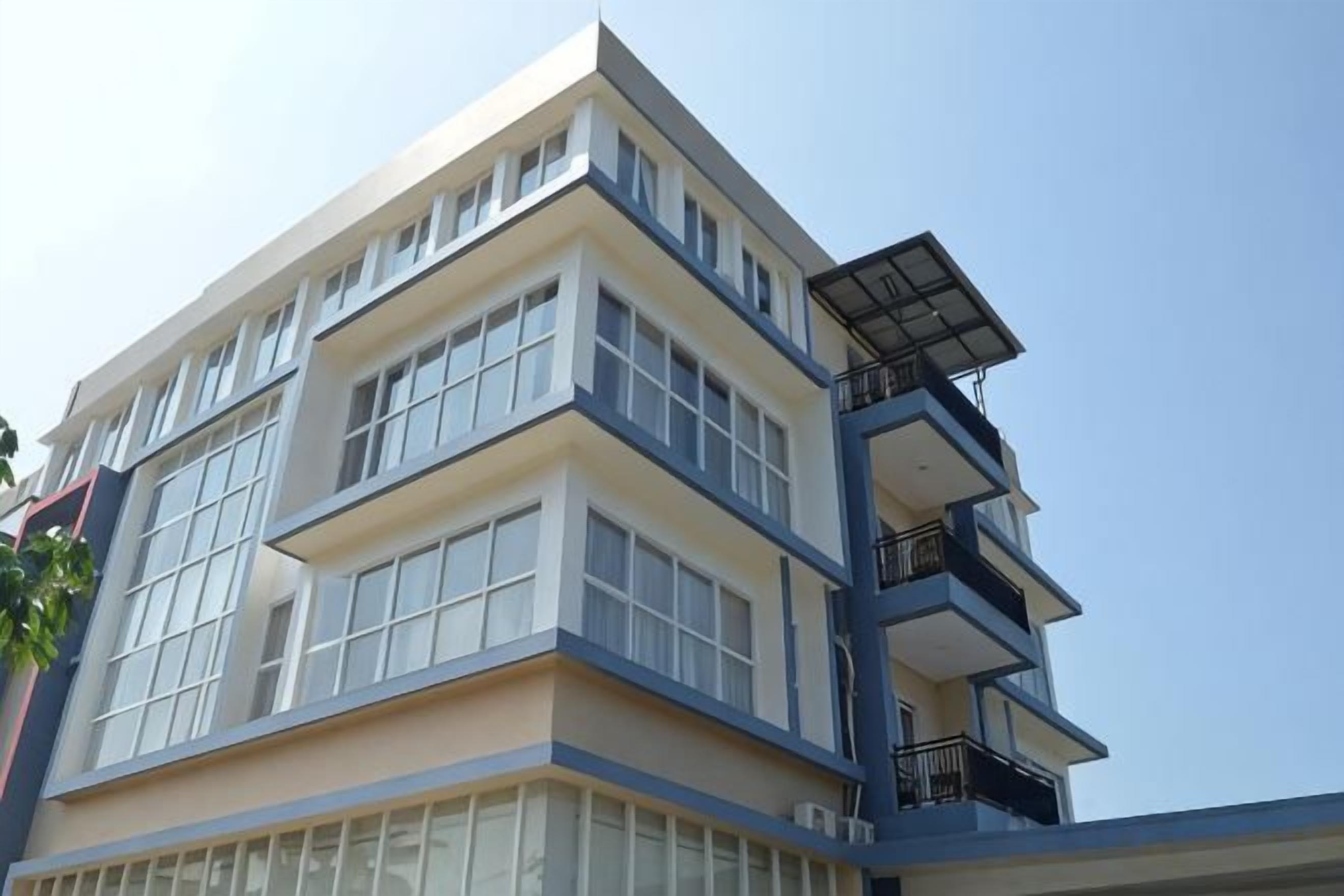 A multi-story building with large windows and balconies.