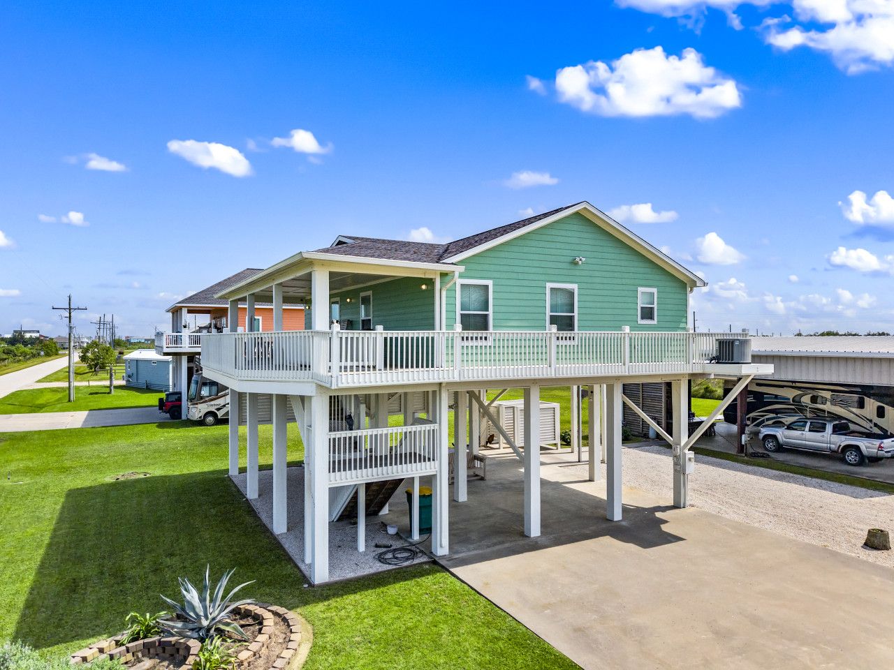 A two-story house with a balcony, a garage, and a driveway.