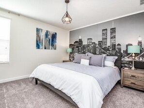 Relax in a stylish bedroom with a large bed, two nightstands, and unique lamps, surrounded by abstract art and a cityscape mural.