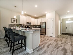 Enjoy cooking in this well-equipped kitchen with a central island and bar stools.