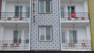 A hotel named "Hotel Ayrdin" with a patterned facade and balconies.