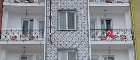 A hotel named "Hotel Ayrdin" with a patterned facade and balconies.
