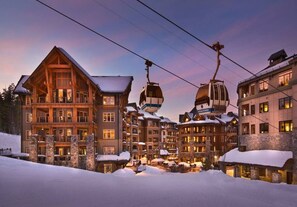 A multi-story lodge with a ski lift, snow-covered ground, and a clear sky. - Northstar Studio w/ Pool, Hot Tub & Sauna Access (Truckee)